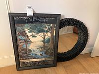 Full view of framed Tolkien print next to decorative mirror showing size and style.
