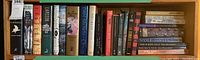 Shelf with approximately 25 books including titles by Larsson, Dan Brown, and others