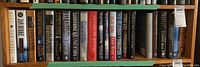 Shelf 1 with various hardcover books by Elizabeth George, Robertson Davies, and others