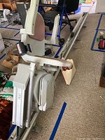 Full view of Acorn stairlift seat mounted on straight rail system in indoor setting.