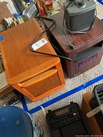 Three space heaters shown together: a wood-finish Sun Twin infrared heater, a black/grey Duracraft heater, and a smaller heater on top.