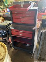 Photo showing All American tool chest with red drawers and black frame on casters, with smaller chest atop the larger cabinet.