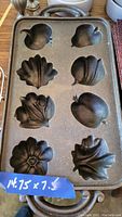 Cast iron mold with detailed fruit shapes, dimensions 14.75" x 7.5"