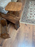 All three items: folding table, magazine rack, and side table, positioned on wooden floor near rug and couch.