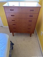 Full front view of the six-drawer dresser on tapered legs