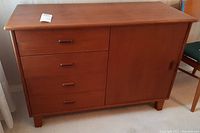 Front view showing four drawers and sliding door