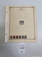 Single Scott stamp album page showing 7 Belgian stamps of varying colors at bottom and one centered upper stamp with ornate border.