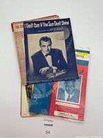 Three vintage sheet music covers featuring Tony Martin with titles 'I Don't Care If The Sun Don't Shine,' 'Domino,' and 'You Can't See The Sun When You're Crying'.