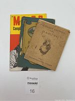 Photo showing all three books stacked, displaying front covers with visible age wear