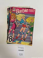 Front photo showing the top comic titled Barbie Fashion Vol.1 No.14 February 1992 with Barbie on roller skates in patriotic outfit and two friends.