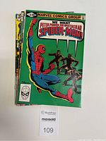 Stack of five Peter Parker The Spectacular Spider-Man comic books with a green cover issue on top featuring Spider-Man and some shadowy figures with text 'We Want Peter Parker The Spectacular Spider-Man'.