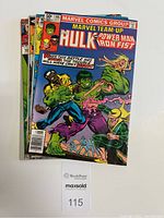 Top view of the 5 comic books stacked with Marvel Team-Up Vol.1 No.105 on top showing cover art with Hulk, Power Man and Iron Fist fighting enemies.