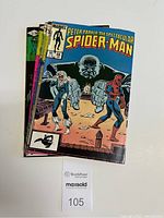 Stack of five Spider-Man comic books from Marvel, showing colorful front covers with Spider-Man and other characters.