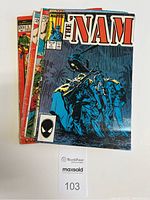 Stack of five comic books featuring front covers; The Nam Vol.1 No.6 May 1987 on top
