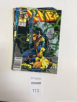 Photo showing a stack of five The Uncanny X-Men comic books, with the top comic being issue No. 262 from June 1990.