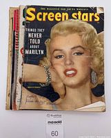 Closed magazine lot showing the cover of Screen Stars November 1954 featuring Marilyn Monroe with a crease and wear damage to corners and edges.