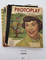 Front cover of the May 1949 Photoplay magazine showing a woman smiling with colorful background illustration of a tree and flowers.