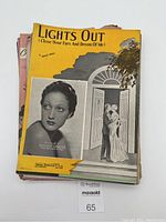 Pile of vintage sheet music with Lights Out on top in yellow cover featuring Dorothy Lamour