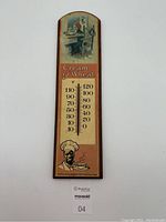 Full view of vintage wooden thermometer with Cream of Wheat illustrations and temperature scale