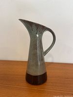 Front and side view of the Blue Mountain Pottery jug showing shape, handle, spout, and glaze color.
