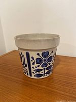 Side view of the ceramic pot showing blue floral designs and crackled glaze.