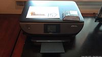 HP Envy 5660 printer closed with additional HP ink cartridge box on top