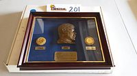Framed shadowbox with JFK bust and two coins, side view showing all contents.