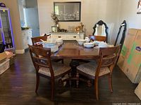Dining set with solid wood rectangular table and four matching chairs. Chairs have upholstered seats and dark wood finish. Photos taken to show overall condition and measurements.