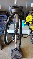 Full view of floor nozzle, wand and hose attached to main unit