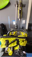 Image showing Ryobi carry bag, vacuum, and tools hanging on wall.