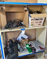 Shelf view showing boxes of cables and electronics