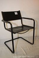 Front and side view of vintage black leather and metal chair with tubular metal frame and leather seat and back.