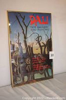 Full view of framed Salvador Dali exhibition poster with clear image of the artwork and exhibition information