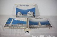 Three boxes of paper model kits depicting US federal buildings and monuments: Jefferson & Lincoln Memorial Models, Washington Monument & White House Models, United States Capitol Model. All boxes show images of the completed paper models.