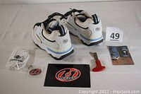 Heelys shoes with accessories including tool, laces, stickers, and manual displayed with lot number