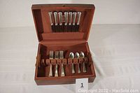 Full view of box open showing 7 forks, 7 knives and 7 spoons in slots