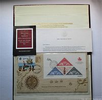 Full set showing presentation case with booklet, stamped envelope, and silver medal in original holder