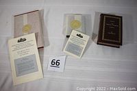 Three hardback reproduction books displayed on a white cloth, each with accompanying informational booklet and Library of Congress seal wrapper