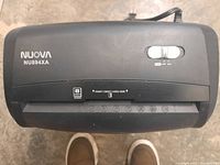 Top view of Nuova NU894XA paper shredder showing control switch and credit card slot.