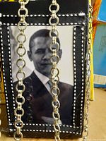 Close-up of purse with Barack Obama portrait and silver chain handles