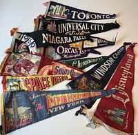 All 11 vintage felt banners arranged showing the variety of designs and locations including Toronto, Niagara Falls, Universal City Studios, Windsor Canada, and more.