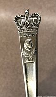 Close-up of spoon handle showing detailed crown design, portrait of Queen Elizabeth, and inscriptions 'CORONATION' and '1953'