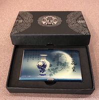 Closed business card holder in black decorative box showcasing blue floral vase and Chinese text on front