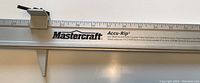 Close-up of Mastercraft branded metal measuring ruler section of the gauge tool with clear measurement markings and model name Accu-Rip.