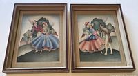 Pair of vintage framed Sandre lithographs showing romantic couples in period costume in brown wooden frames.