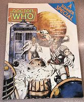 Front colorful cover featuring Doctor Who TARDIS, Daleks, and characters with explosion effects and logo.