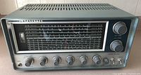 Front view of vintage Lafayette radio showing tuning scale, brand name, and multiple knobs.