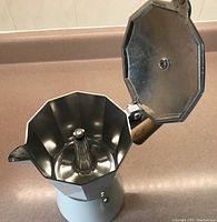 Photo of opened Gnali & Zani coffee maker showing the interior, spout, filter funnel, and metal lid hinge detail.