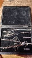 Photo of the entire set of antique drawing instruments inside a velvet-lined black case with a Thornton label.