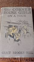 Front cover of The Corner House Girls on a Tour book showing title, author, and illustration of three girls.